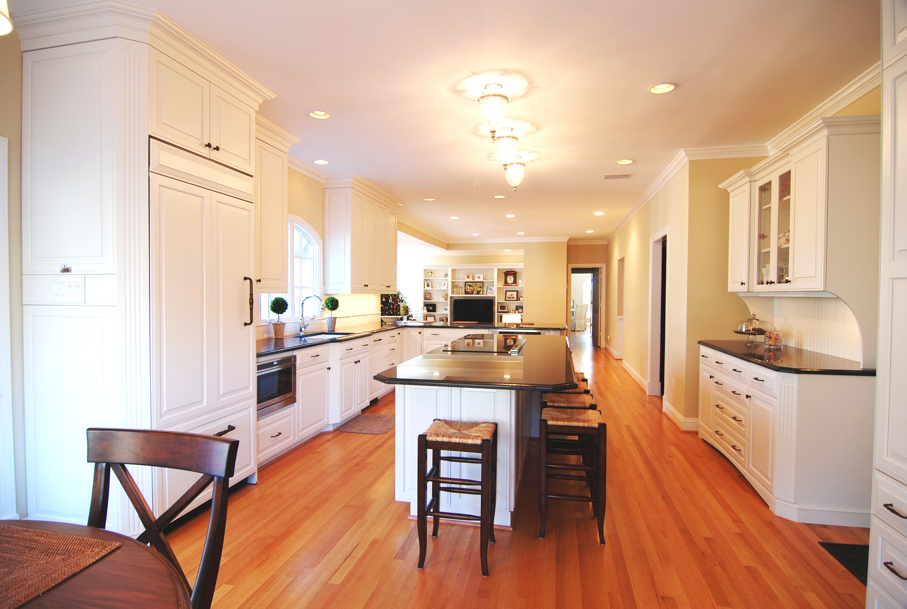 White Kitchen Photo with Wood Floors