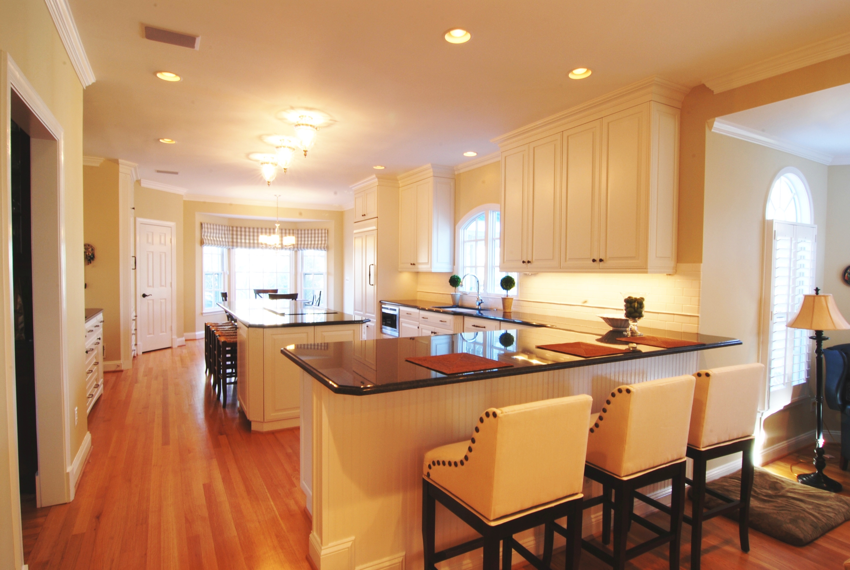 White Kitchen Photo with Wood Floors